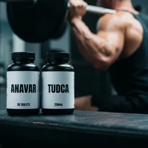 Realistische Aufnahme eines Anavar und TUDCA Supplement-Stacks auf einer Trainingsbank, der den sicheren oralen Anfänger-Kurplan für leanen Muskelaufbau visuell veranschaulicht.