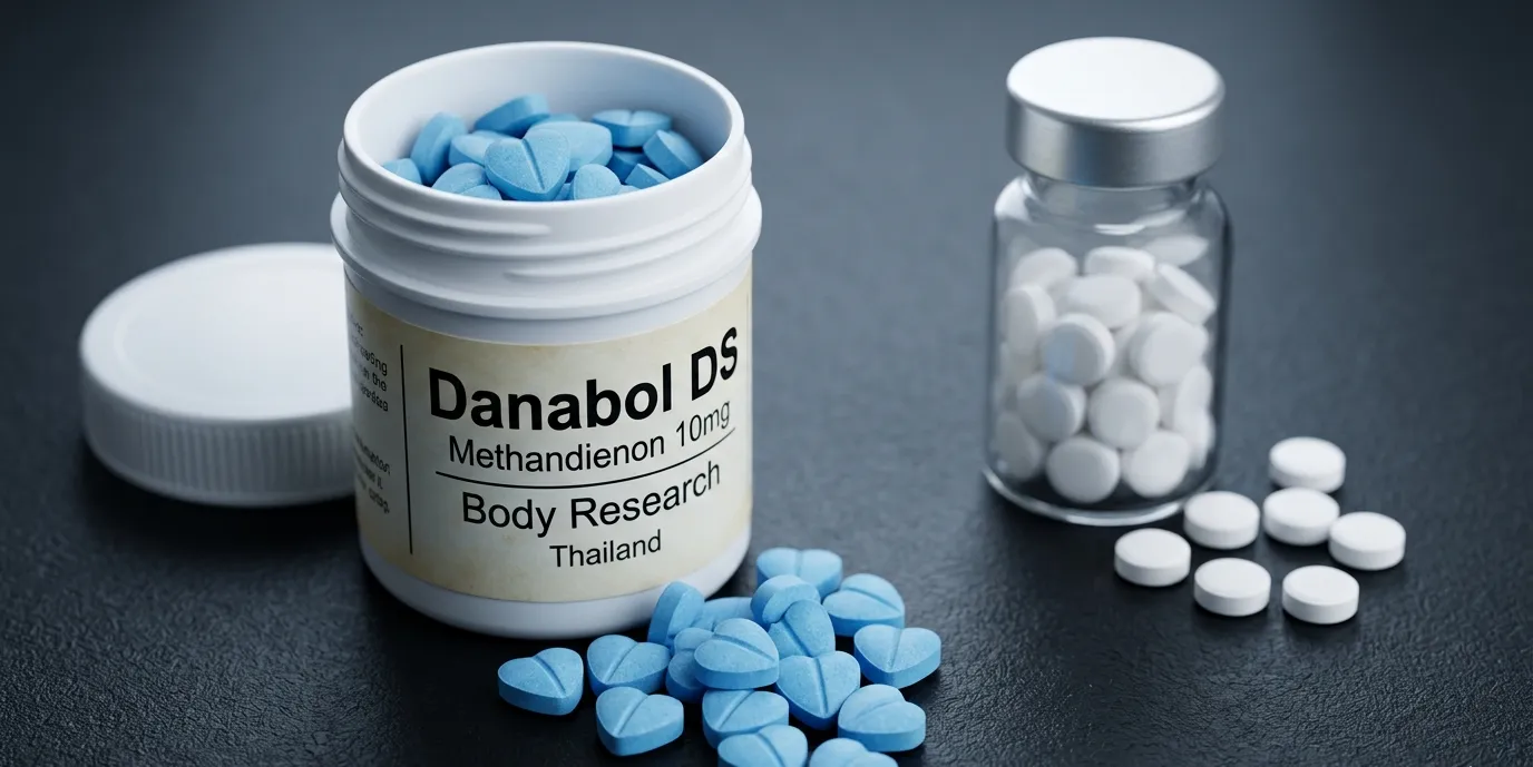 Danabol DS gegen heutiges Methandienon: Old-School-Mythos und Echtheitsfrage 9 Danabol-DS-500er-Dose Body-Research-Thailand mit blauen herzförmigen Methandienon-10mg-Tabletten im Vordergrund neben generischem modernem Methandienon-UGL-Produkt mit weißen Rundtabletten – Old-School-Mythos-Vergleich: identischer Wirkstoff Methandienon seit Ciba-Dianabol-Einführung 1958, Echtheitsmerkmal blaue Herzform mit Body-Research-Prägung vs UGL-Generika ohne Markenkennzeichnung